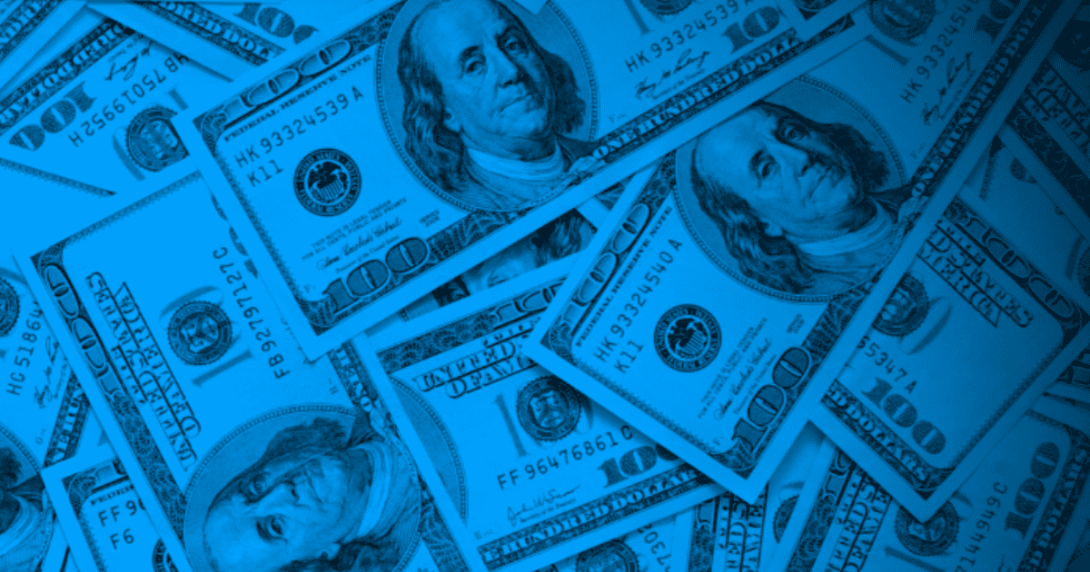 Photo of pile of 100 dollar bills with Benjamin Franklin's face